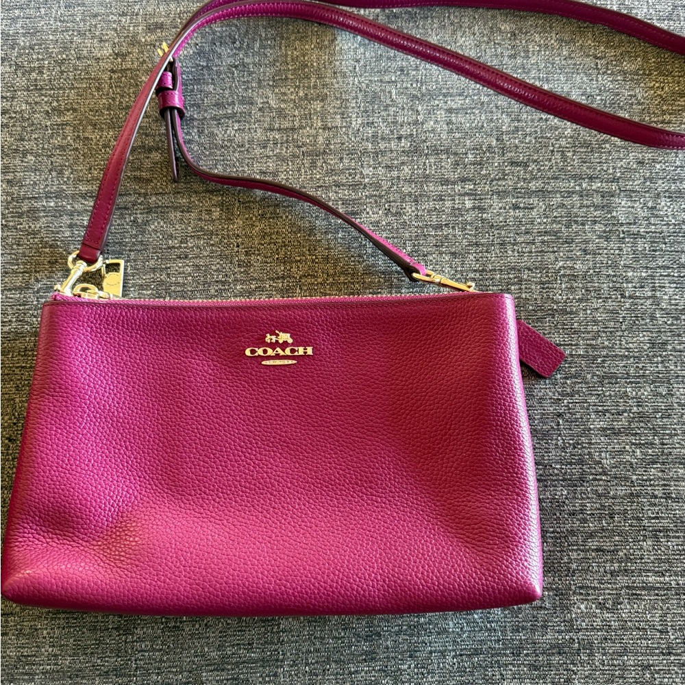 Coach Magenta pebble leather crossbody bag with 2 zippered compartments .